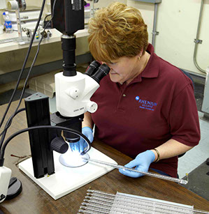 Rhenium Alloys expert staff inspecting tubes in lab